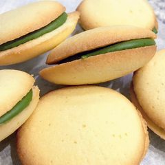 A picture of Langue de Chat Cookies with Matcha Chocolate filling.