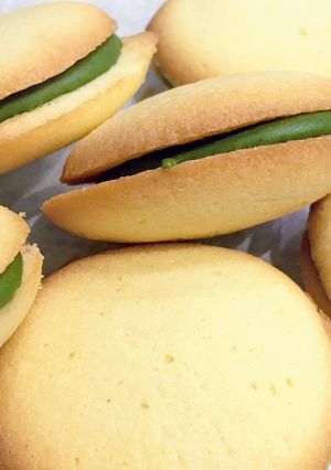 A picture of Langue de Chat Cookies with Matcha Chocolate filling.