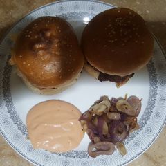 A picture of Creamy Beef Burger with Dip sauce and Caramelized Onions.