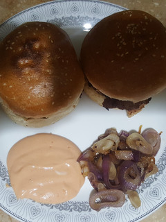 A picture of Creamy Beef Burger with Dip sauce and Caramelized Onions.