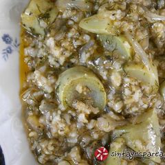 A picture of Zucchini rice with tomato and herbs.