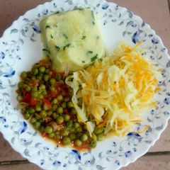 A picture of Mashed potatoes, fried peas and steamed cabbage.