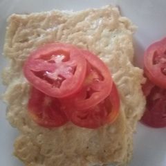 A picture of Heavy omelette with tomato slices.