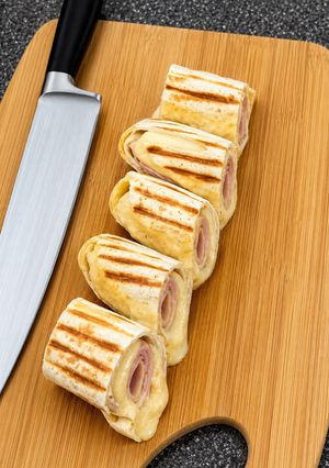 Una foto de C-H-E-E-S-Y Ham Burrito