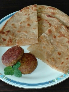 A picture of Paratha and Beef Boti Kabab.
