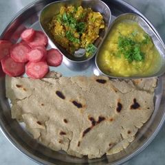 A picture of Baigun bharta, dal,bhakri.