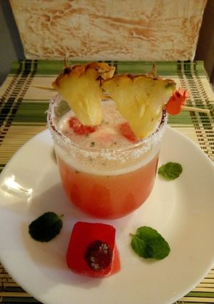 A picture of Pineapple juice with Rose syrup ice cubes#4weekchallenge.