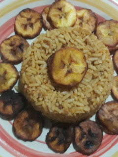 A picture of Jollof rice with fried plantain.