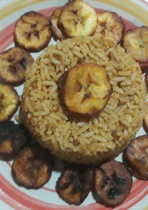 A picture of Jollof rice with fried plantain.