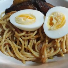 A picture of Spagetti,fried plantain and  boiled egg.