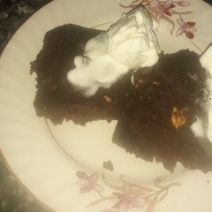 A picture of Chocolate brownies with vanilla ice cream.