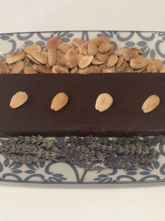 Una foto de Turrón de chocolate negro y aromas florales con almendras tostadas