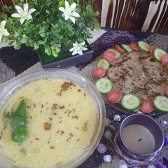 A picture of Urad/maash ki khatti daal with bajrey ki roti.