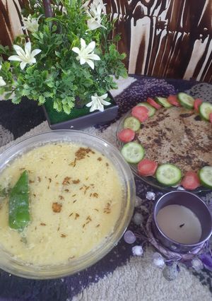 A picture of Urad/maash ki khatti daal with bajrey ki roti.