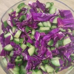 A picture of Cucumber and red cabbage with vinegar dressing.