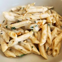 A picture of Cream cheese pasta with pine nuts and cranberries.
