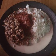 A picture of White rice, beans and stew.