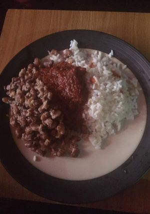 A picture of White rice, beans and stew.