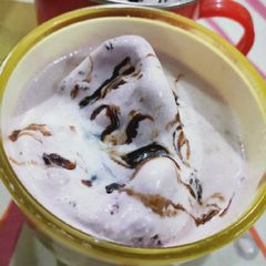 A picture of Banana shake with black current ice cream.