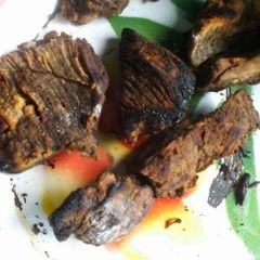 A picture of Traditional way of roasting beef and making its stew.
