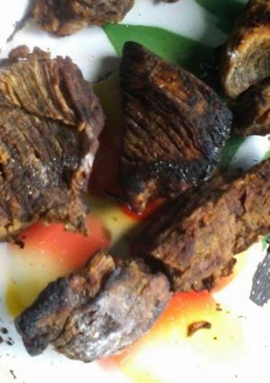 A picture of Traditional way of roasting beef and making its stew.