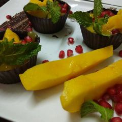 A picture of Mango Mousse in Chocolate Tarts.