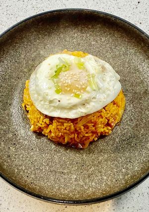 A picture of Kimchi fried (with bacon and a fried egg).