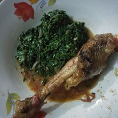 A picture of Chicken stew with greens.