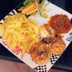 A picture of Fried irish potatoes,prawns and sauce.