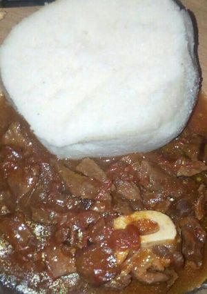 A picture of Ugali with stewed meat.