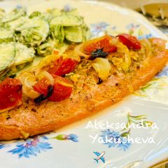 A picture of Trout fillet baked with tomatoes.