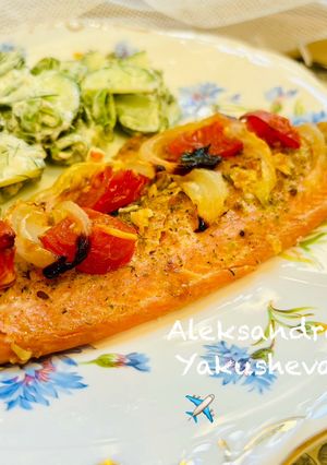 A picture of Trout fillet baked with tomatoes.