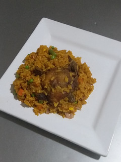 A picture of Jollof Rice and Chicken.