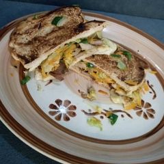 A picture of Grilled beef and vegetable fries sandwich.