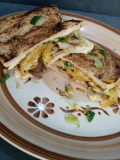 A picture of Grilled beef and vegetable fries sandwich.
