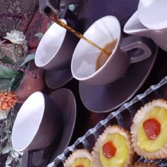 A picture of Lemon tarts with tea.