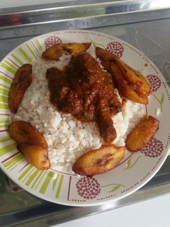 A picture of White Rice, chicken stew and plantain.