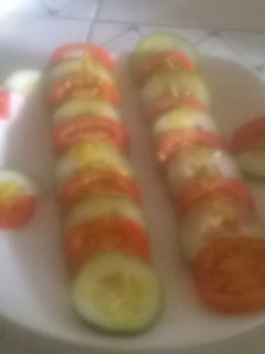 A picture of Tomato and cucumber salad.