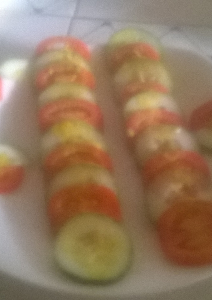 A picture of Tomato and cucumber salad.