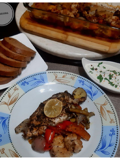 A picture of Baked chicken with Potato and other veggies.