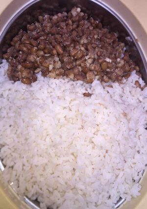 A picture of White rice nd beans with salad.