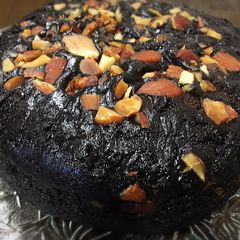 A picture of Rich chocolate cake with roasted almonds.