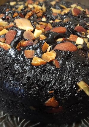 A picture of Rich chocolate cake with roasted almonds.
