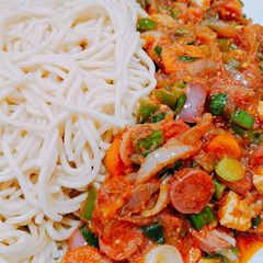 A picture of Spaghetti and sausage sauce.