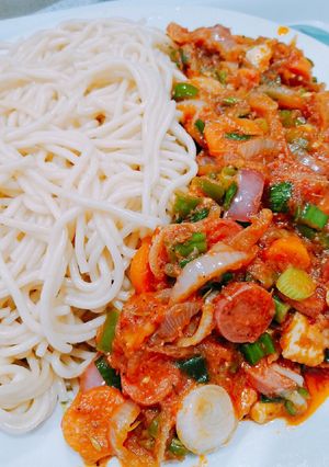 A picture of Spaghetti and sausage sauce.