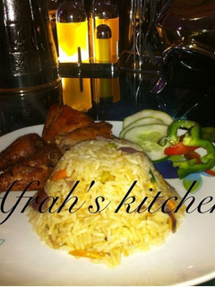 A picture of Jollof rice with fried chicken.