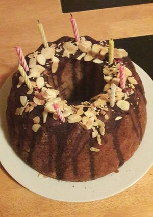 A picture of Apple bundt cake with flaked almonds.