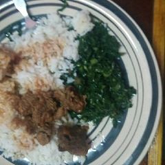 A picture of Beef stew served with Rice and veges.