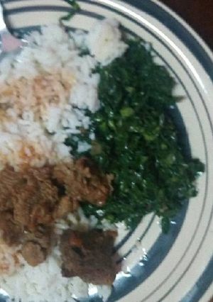 A picture of Beef stew served with Rice and veges.