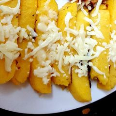 A picture of Polenta Chips with mozarella cheese & Italian herbs.